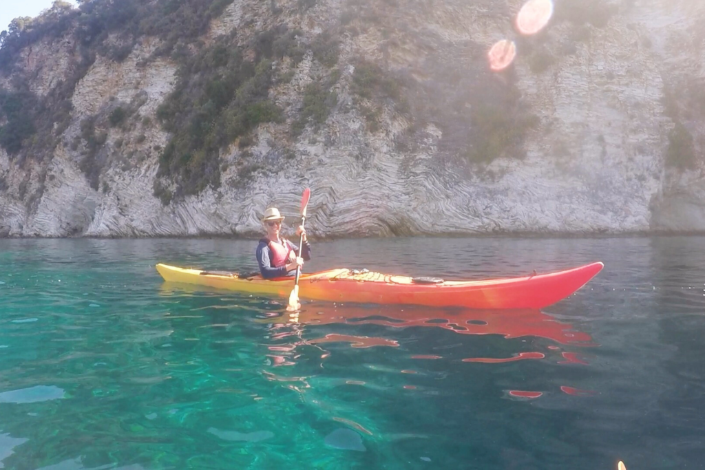 in a sea kayaking floating along the white cliffs of Lefkada