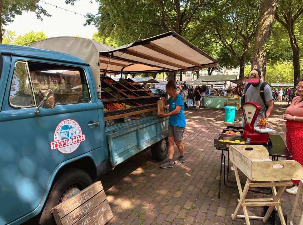 market in ouden noorden, lady selecting fruit from her pickup truck for her customers