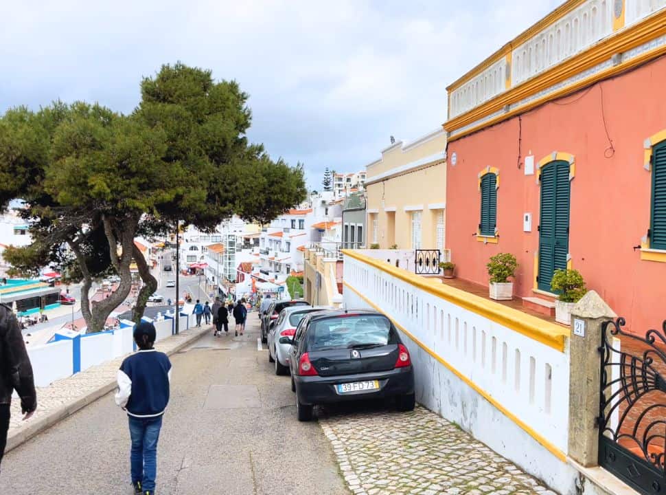 hilly road with parked cars at carvoeiro portugal
