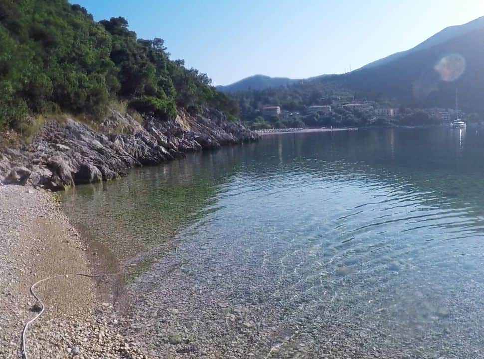 little sandy beach with view of mikros gialos village