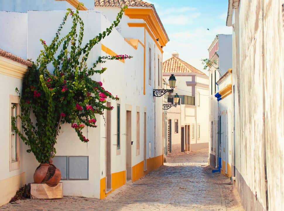 beautiful white houses with yellow colours in faro city portugal