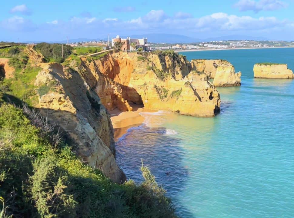 view of Praia do Pinhão with a boardwalk near lagos town portugal