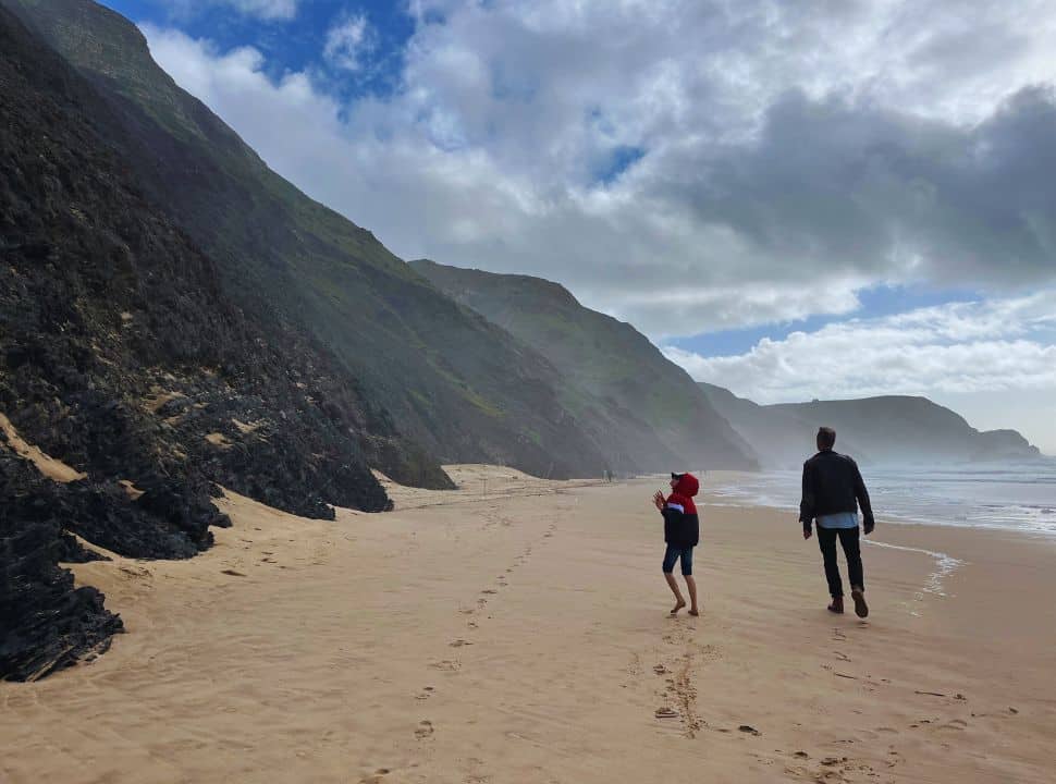 cliffs, clouds, waves and soft sand at praia da cordoama