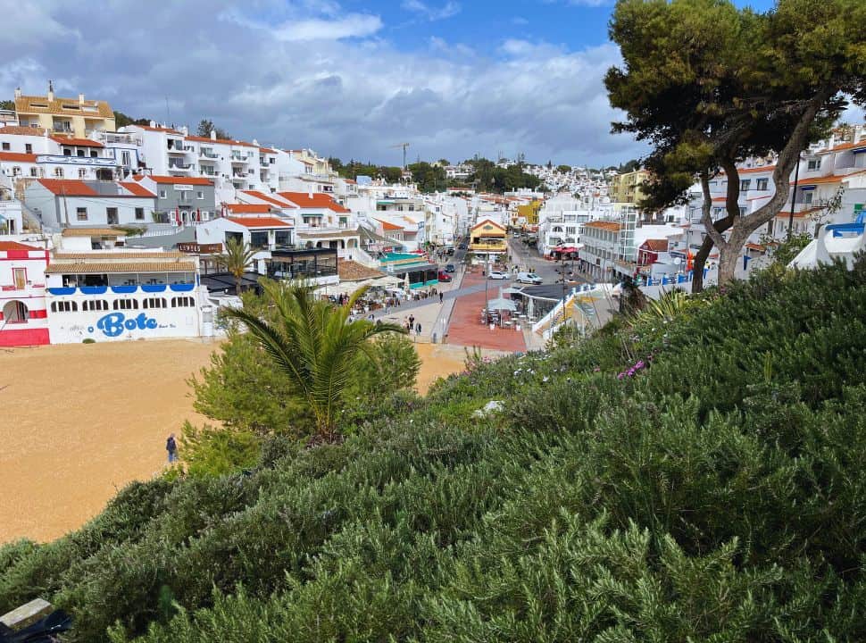 beach and white building at carvoeiro beach algarve