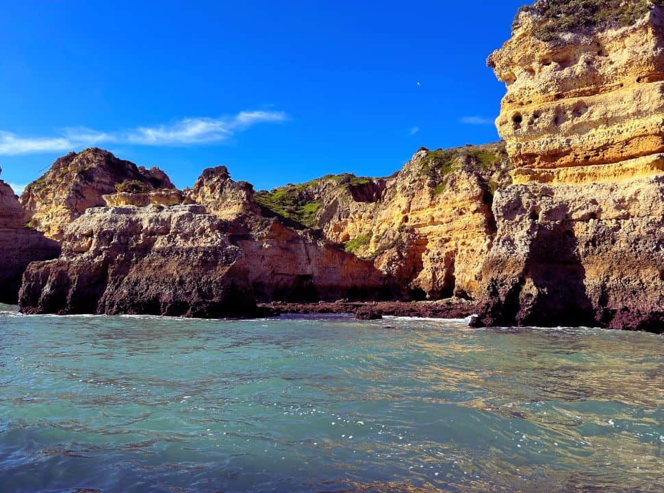 view of the cliffs along the algarve coast line from the water