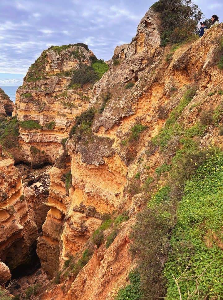 large pit hole with various shades of orange and red at the algarve portugal