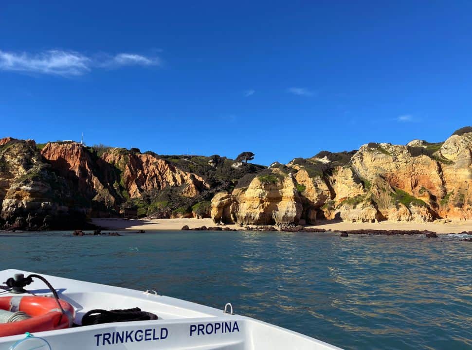 a beach in the algarve seen from the boat