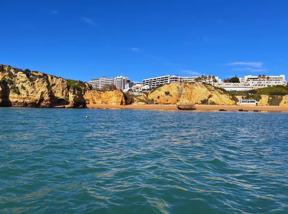 view from the water at Dona Ana beach with high rise resorts at the algarve Portugal