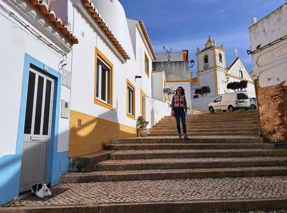 stairs, colorful houses, cat and church at ferragudo the Algarve