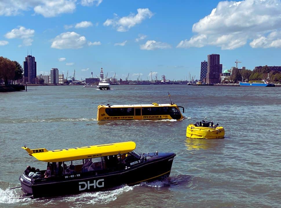 the yellow floating bus from the Splashtour together with the water taxi on the Maas river Rotterdam