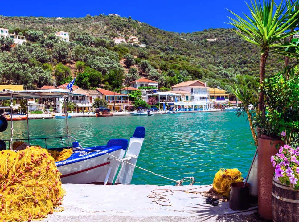 colorful flower, emerald green water and beautiful buildings set in the harbour at sivota lefkada