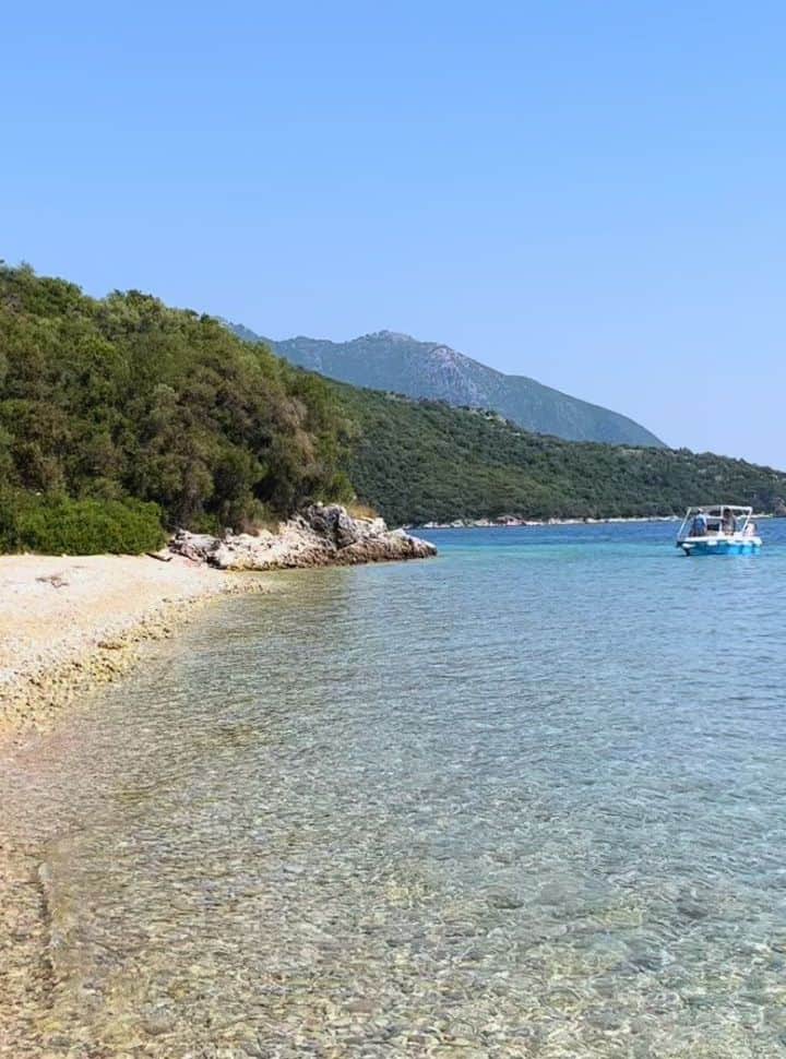 small rental boat arriving at a deserted beach in the east of Lefkada