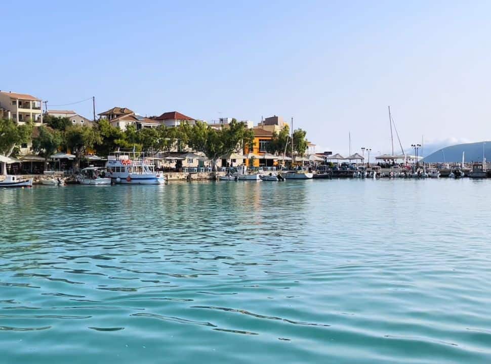 view of Vasiliki Marina with emerald colour water, boats docked and colourful houses