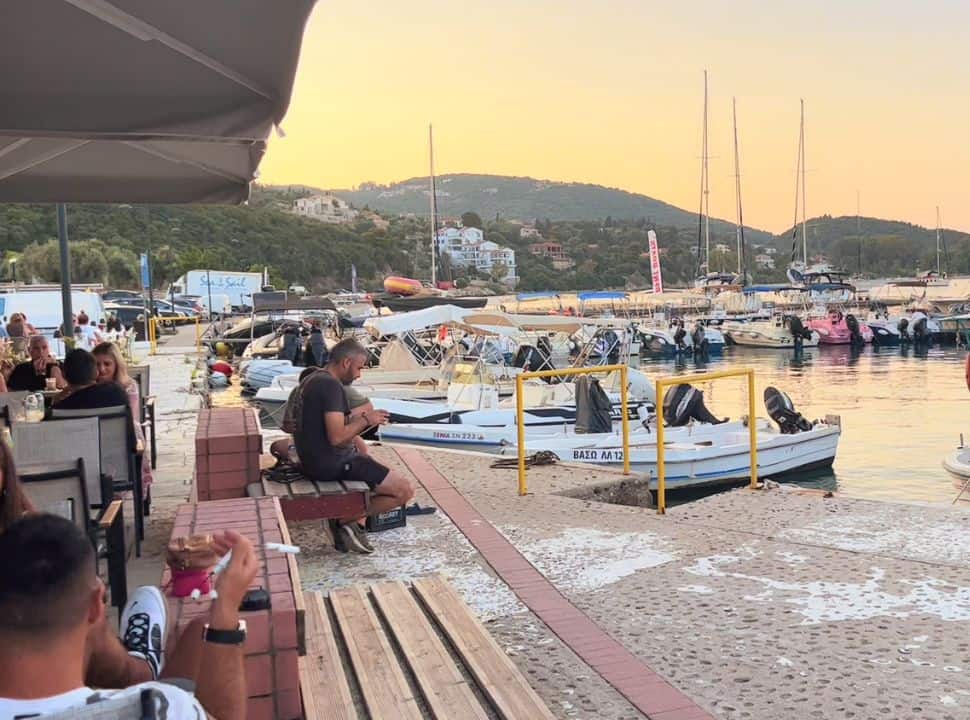 people enjoying dinner at Nikiana marina with a sunset 