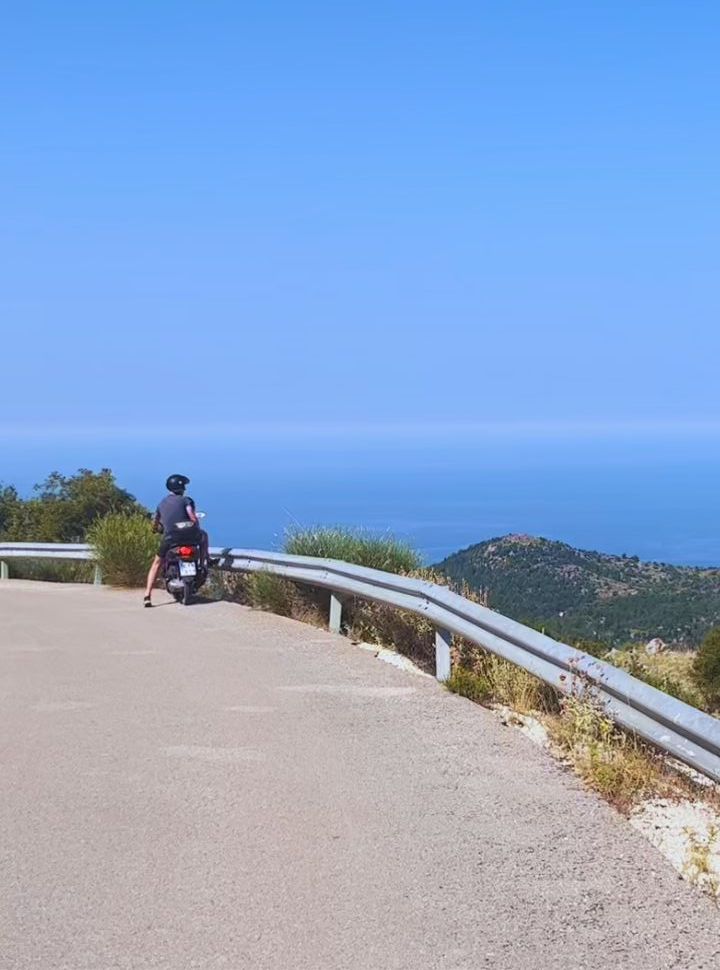 driver taking in the beautiful ocean and mountain views in Lefkada