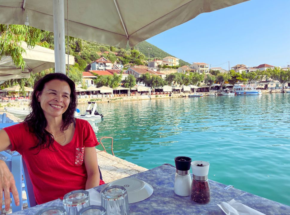 woman sitting at a restaurant at the water quay in Vasiliki Lefkada