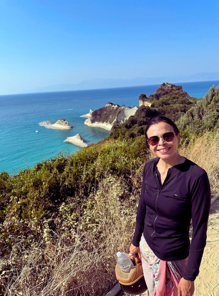 woman posing with view of cape drastis in the back