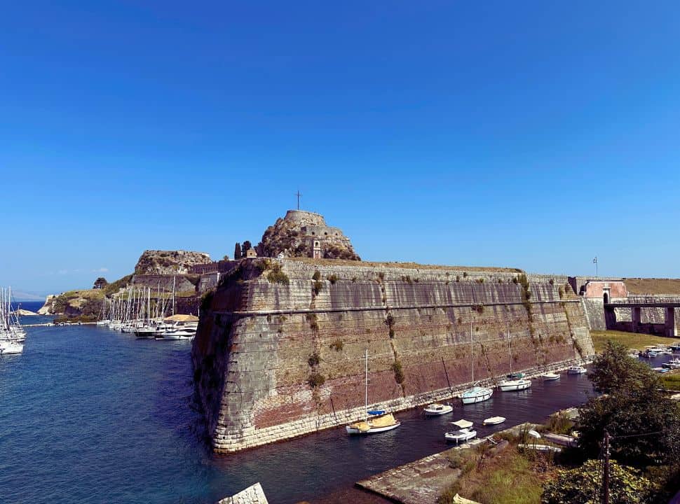 the outside walls of the old fortress in  corfu town surrounded by water