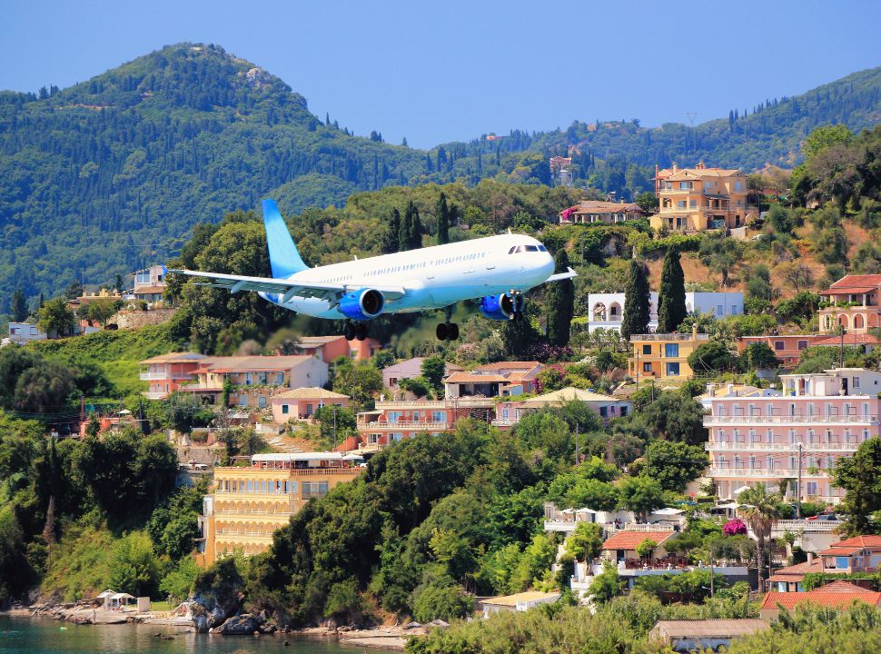 airplane flying very low over the water while approaching corfu airport