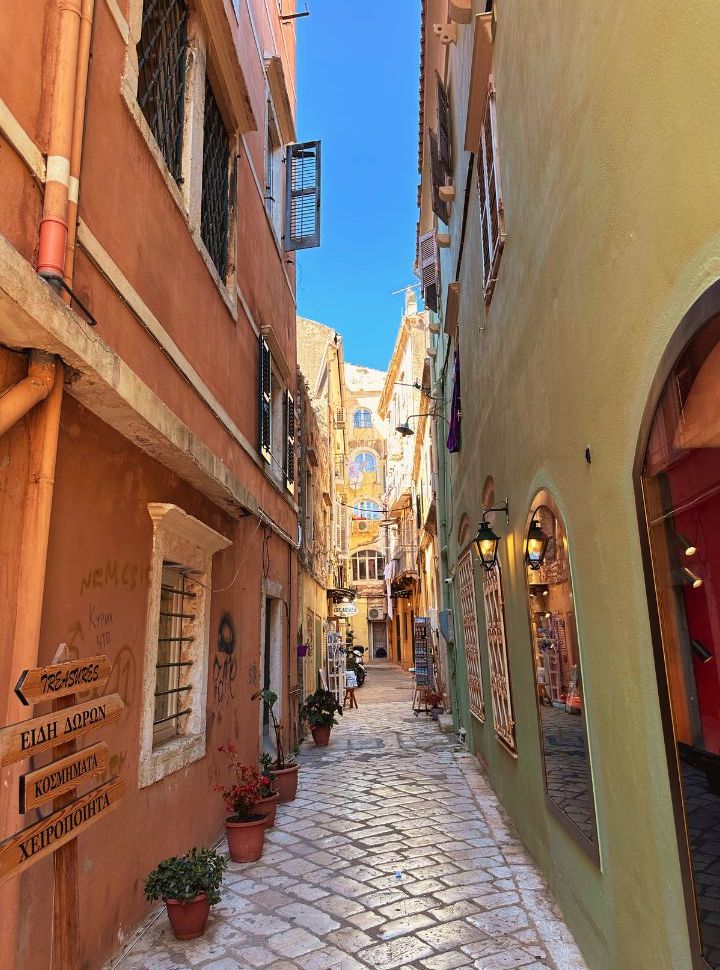 alleyway with a green and ochre red building in corfu town