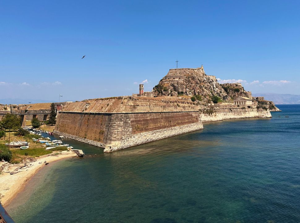 a small patch of beach is visible just outside the walls of the old fortress in corfu town