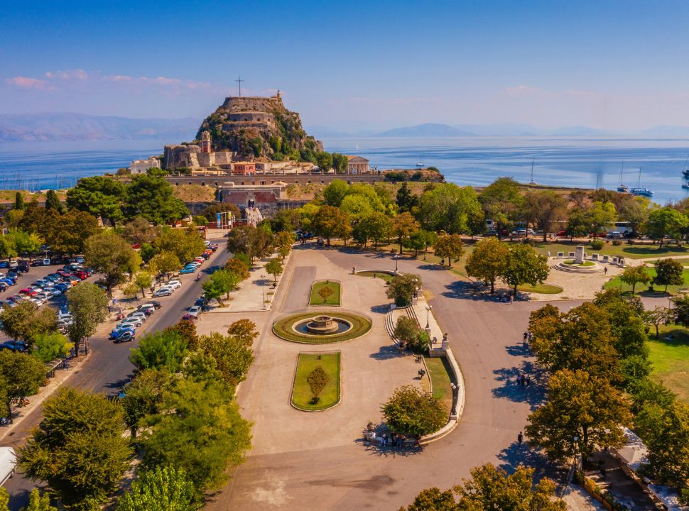 a part of the largest square in greece with the old fortress towering in the back