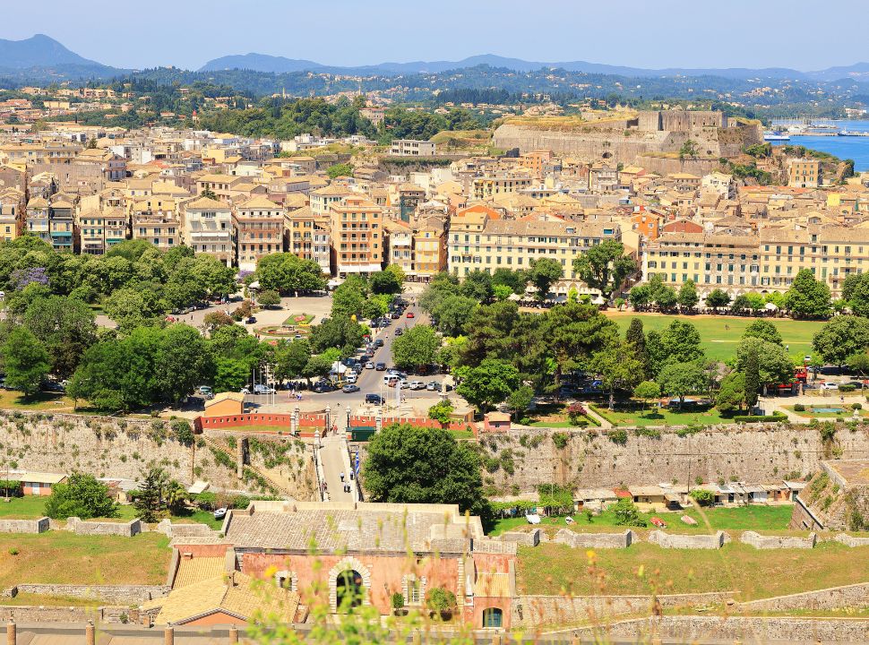 stunning view of Spianada square, historical buildings of old corfu, the new fortress and the mountains of corfu far beyond