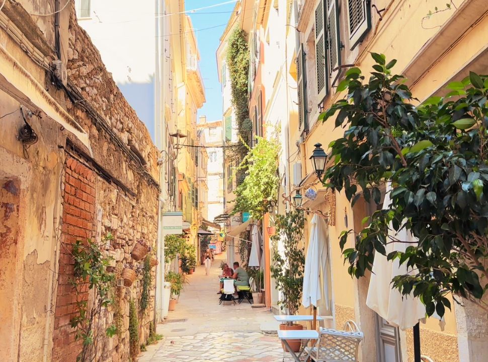 small narrow streets with a couple sitting at a restaurant