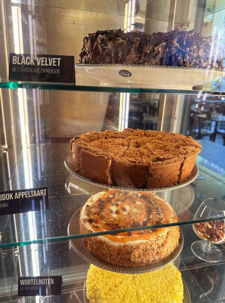 four pies displayed: black velvet, applepie, carrot nuts cake and red velvet cake