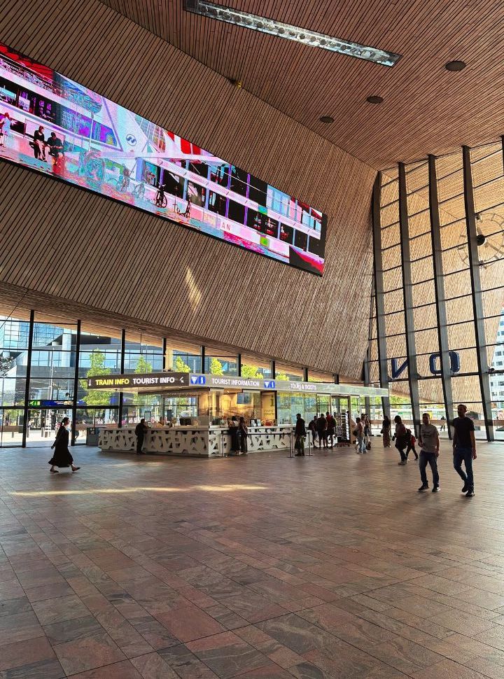 hall of train station with wooden ceiling and a huge screen