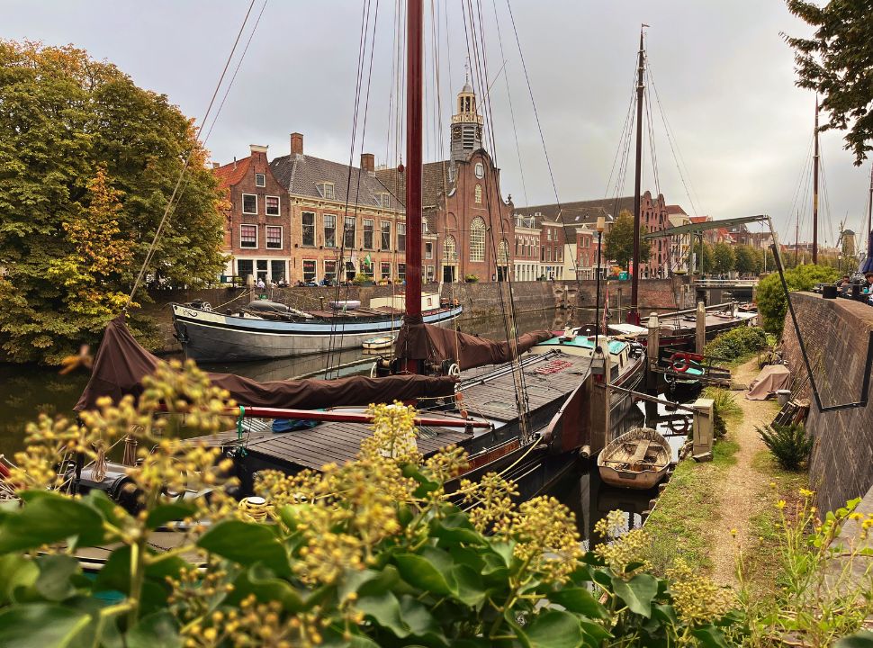 the historic buildings of Delfshaven along the canal with boats in Rotterdam