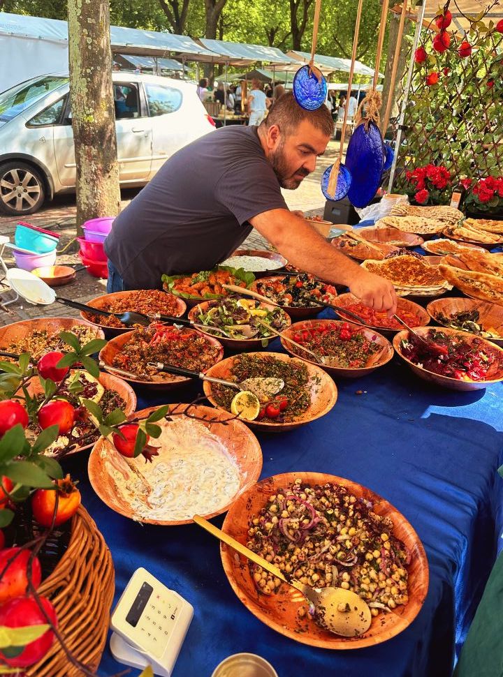 man selling all types of salads and dips at the market in Rotterdam