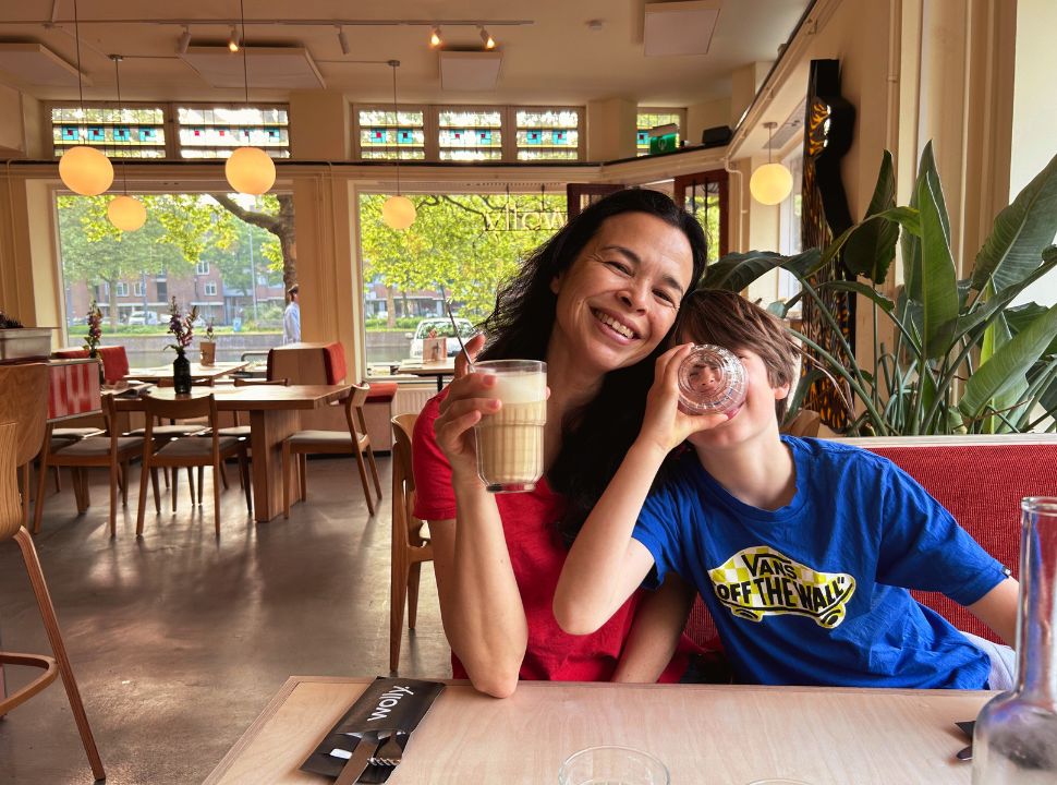 mother and son enjoying a drink while waiting for their food at a restaurant in rotterdam