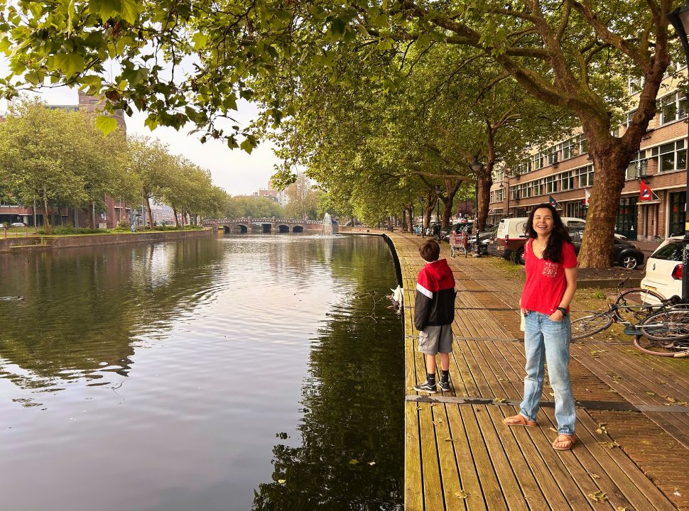 mother and son walking along the river in an old part of Rotterdam