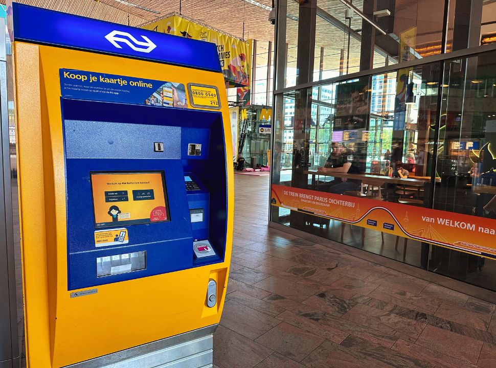 yellow and blue train ticket machine at the station in Rotterdam