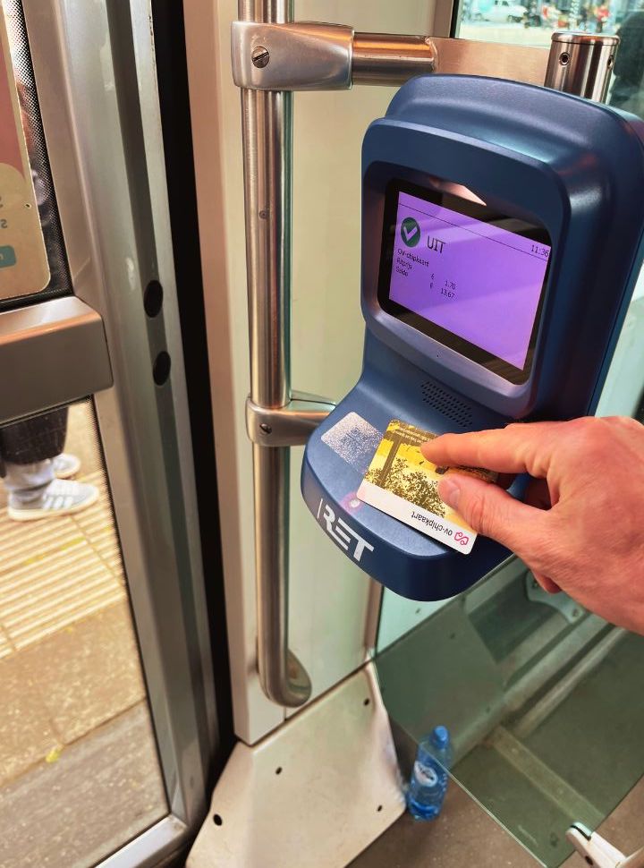 man using his travel card to check-out before desembarking the tram in Rotterdam