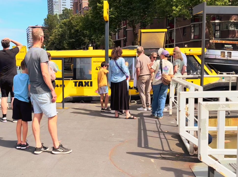 yellow watertaxi picking passengers up at one of their pick up points in Rotterdam