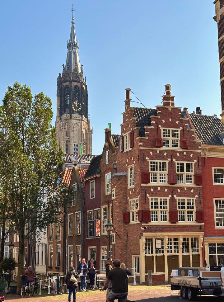 stunning old buildings in delft city center with the tall tower of the new church in the back