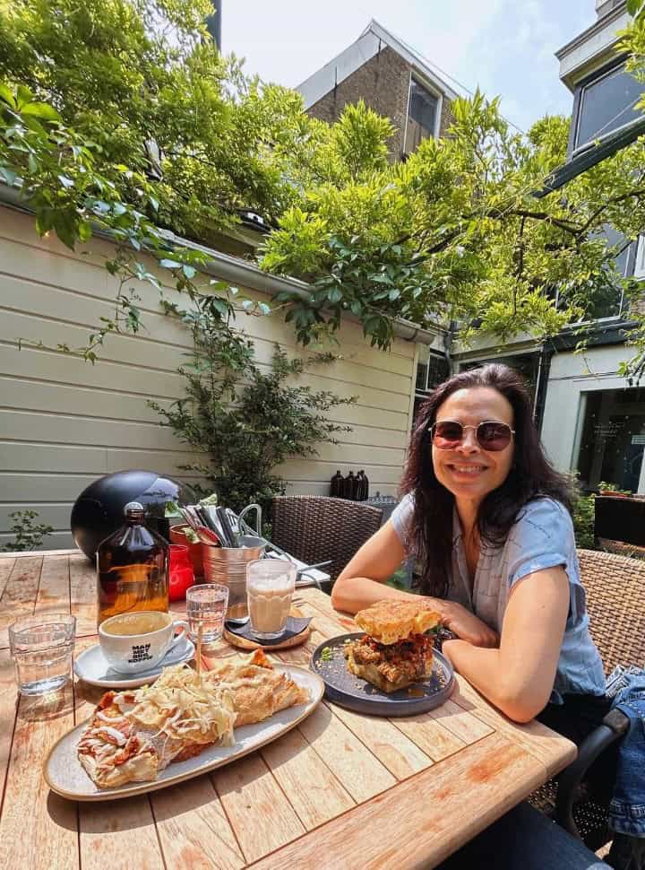 woman having lunch in the garden of a restaurant in delft