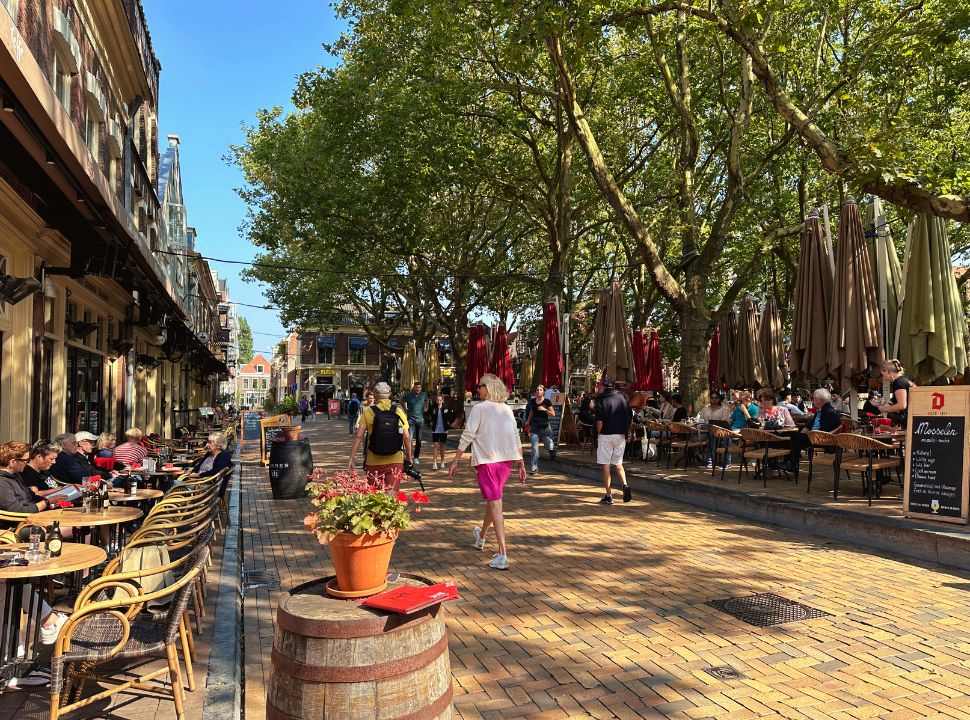 people enjoying drinks and lunch at the beesten square in delft on the terrace