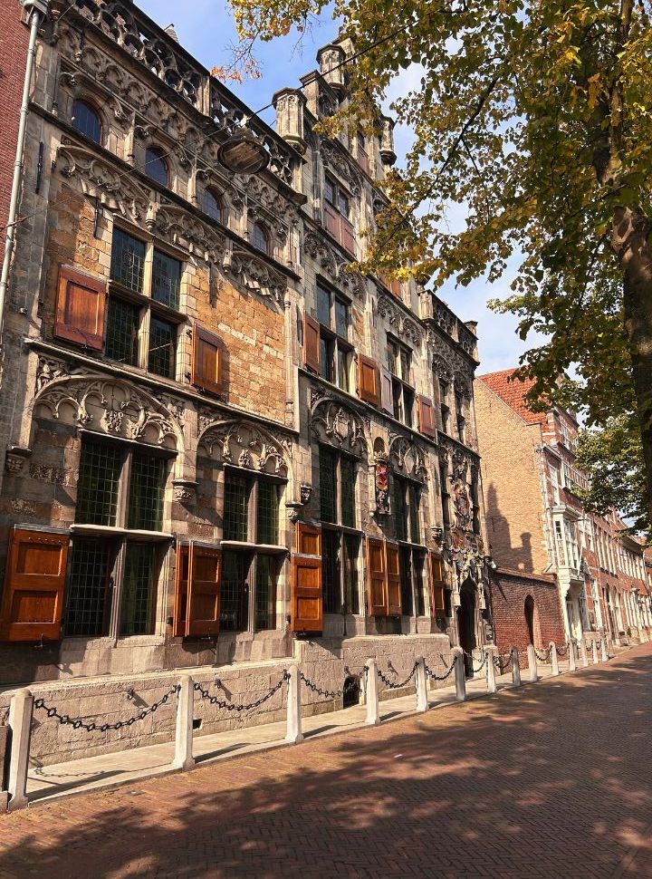 stunning old building with shutters and decoration along a small street in Delf