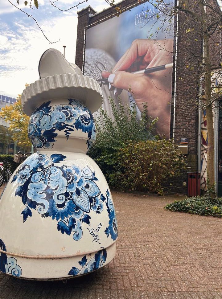 delft blue sculpture at the entrance of the factory located in a historic old building