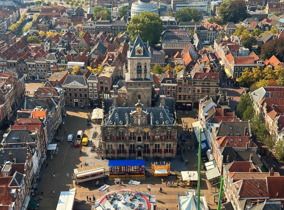 semi-aerial view of the delft city hall and its market square with its surrounding dutch historic buildings