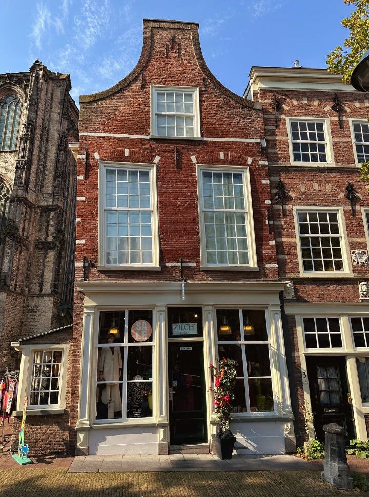 window shop with a display of women cloths set in a old historc delft building