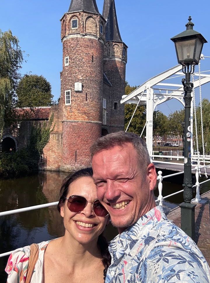 woman and man posing in front of the east gate (bridge and towers) in Delft