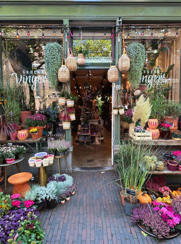 flower shop in delft with colourful display of flower, pots and candles