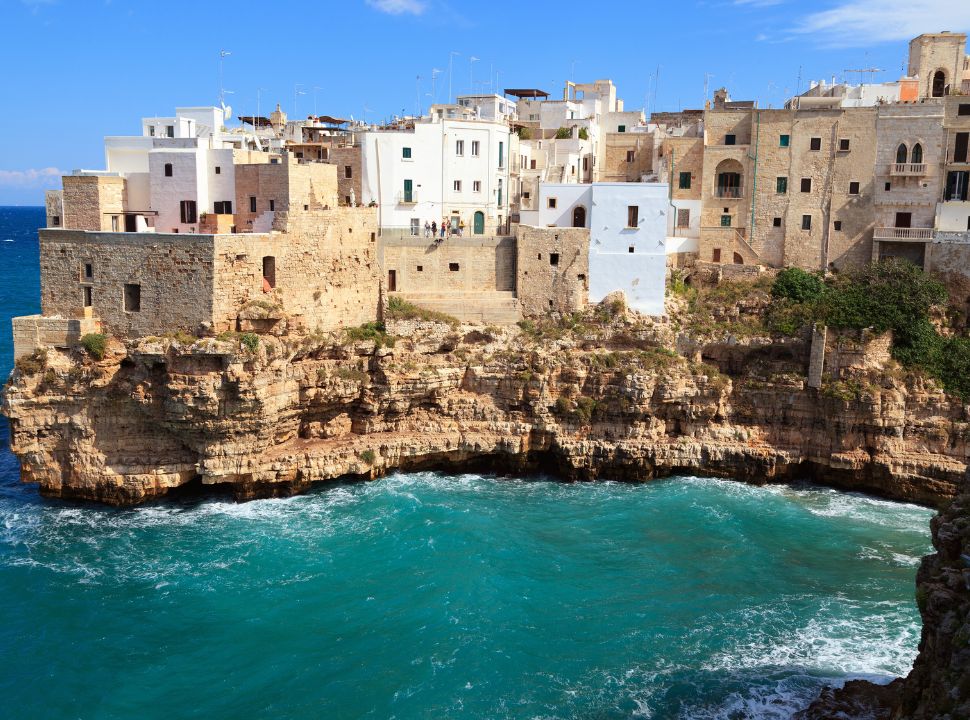 view of the houses perched on the cliff edge in Polignano a mare Puglia