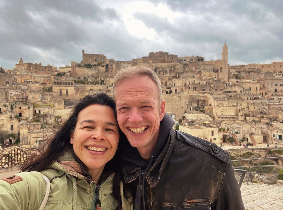 couple posing in front of the sassi district in matera italy