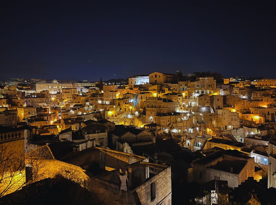 view of Matera by night, beautifully lit houses and alleys