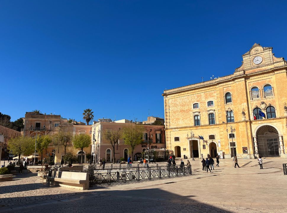 main square in Matera with a tall buliding and smaller ones around it